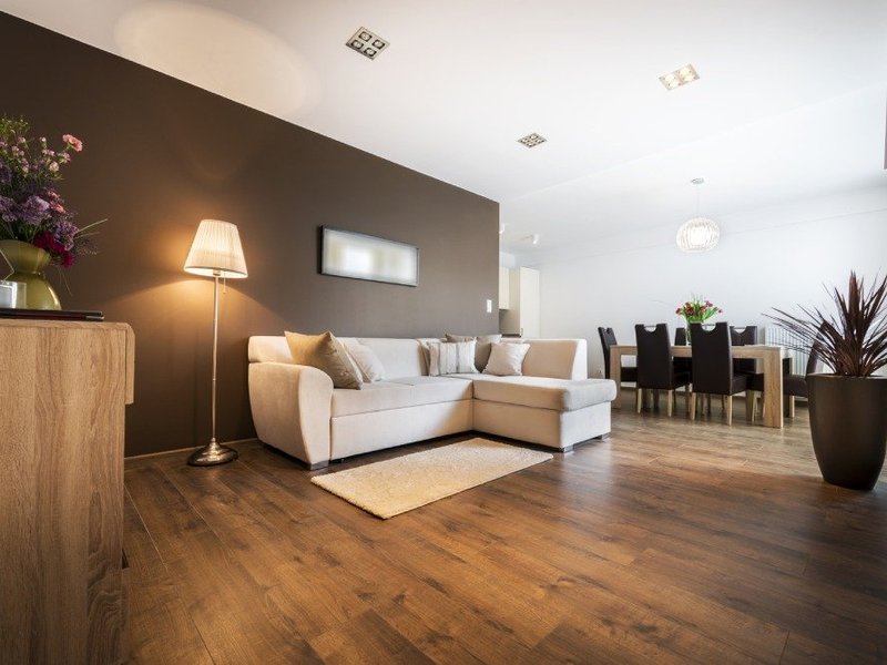 brown hardwood floor and white couch in West Suite F Clayton, NC area by by Clayton Flooring Center